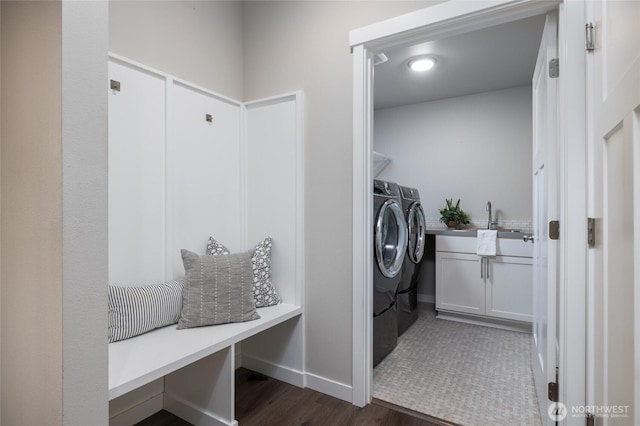 laundry room featuring independent washer and dryer, dark wood-style floors, and baseboards