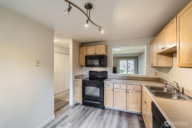 23723 12th Pl S Unit 2005, Des Moines, WA 98198 - kitchen with black appliances, a sink, light brown cabinetry, light wood-type flooring, and light countertops