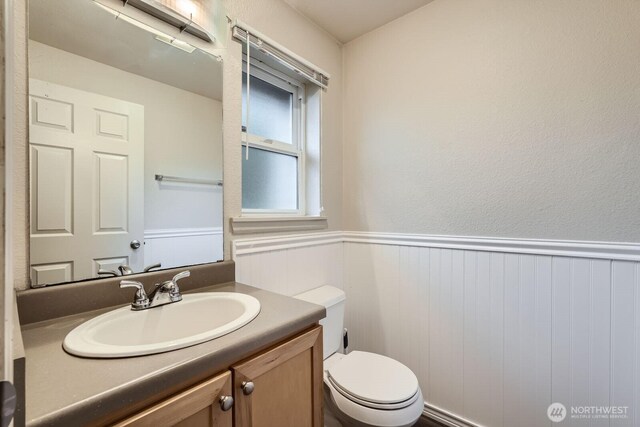 23723 12th Pl S Unit 2005, Des Moines, WA 98198 - half bath with a wainscoted wall, vanity, and toilet