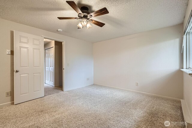 23723 12th Pl S Unit 2005, Des Moines, WA 98198 - unfurnished bedroom with carpet flooring, a textured ceiling, baseboards, and ceiling fan