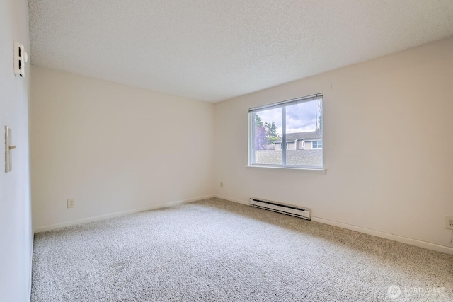 23723 12th Pl S Unit 2005, Des Moines, WA 98198 - carpeted empty room featuring a baseboard radiator, baseboards, and a textured ceiling