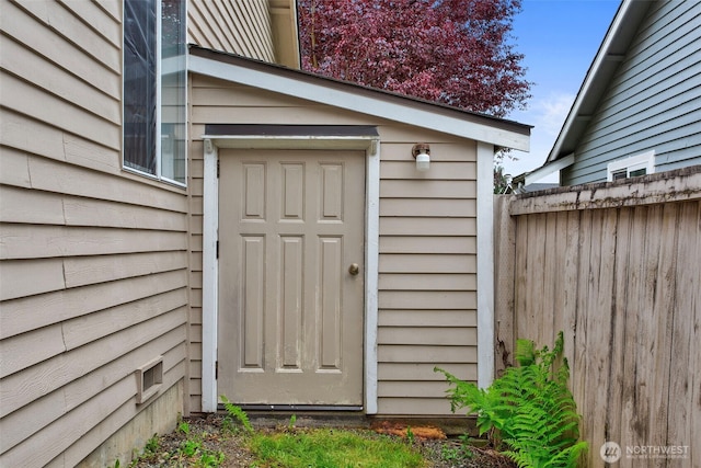 doorway to property with fence
