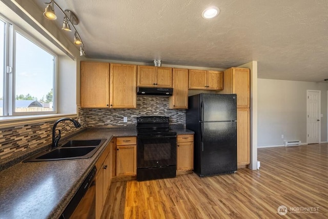 301 E Silberhorn Rd, Sequim, WA 98382 - kitchen with black appliances, a sink, under cabinet range hood, dark countertops, and tasteful backsplash