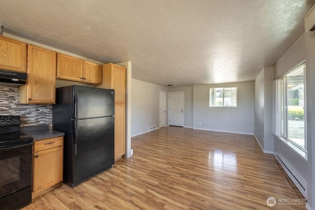 301 E Silberhorn Rd, Sequim, WA 98382 - kitchen featuring black appliances, range hood, a baseboard radiator, light wood-type flooring, and tasteful backsplash