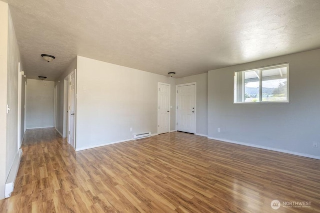 301 E Silberhorn Rd, Sequim, WA 98382 - unfurnished room featuring wood finished floors, a textured ceiling, and baseboards