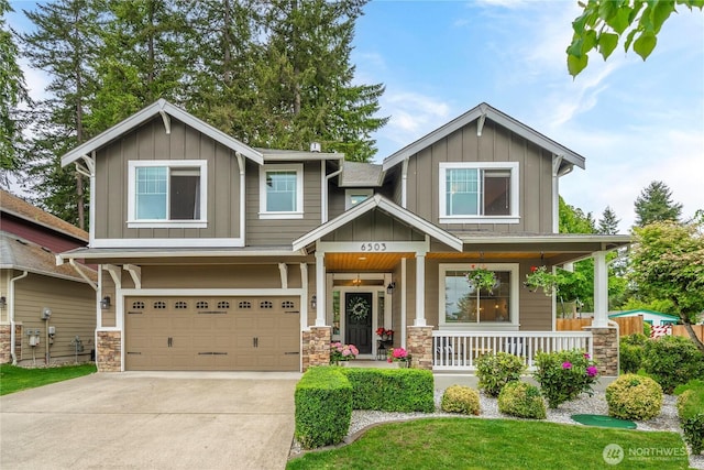 6503 Wrangler Dr SE, Tumwater, WA 98501 - craftsman house with board and batten siding, covered porch, an attached garage, and driveway