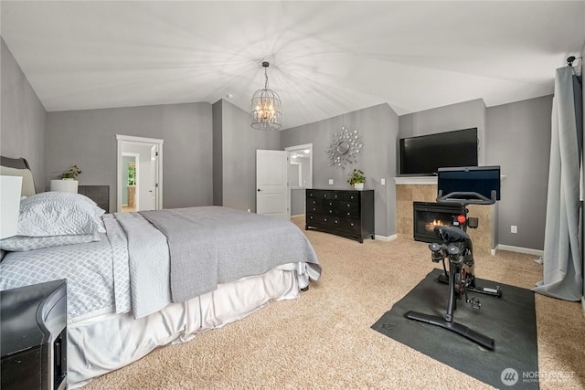 6503 Wrangler Dr SE, Tumwater, WA 98501 - bedroom with carpet floors, lofted ceiling, a tiled fireplace, and a chandelier