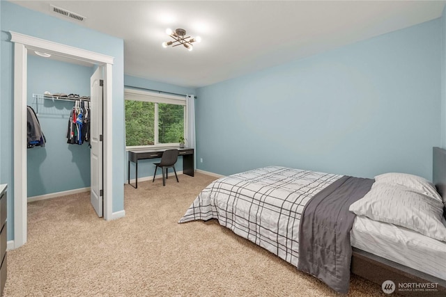 6503 Wrangler Dr SE, Tumwater, WA 98501 - carpeted bedroom featuring a walk in closet, baseboards, and a closet