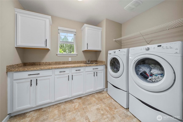 6503 Wrangler Dr SE, Tumwater, WA 98501 - laundry room with washer and clothes dryer, cabinet space, and stone finish flooring