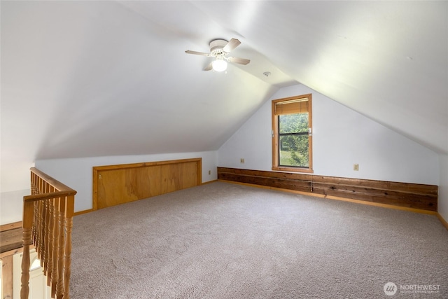 additional living space with ceiling fan, vaulted ceiling, and carpet flooring