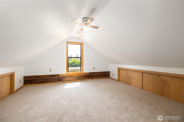 additional living space with vaulted ceiling, ceiling fan, and carpet flooring