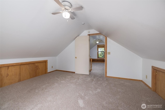 bonus room featuring vaulted ceiling, carpet flooring, baseboards, and ceiling fan