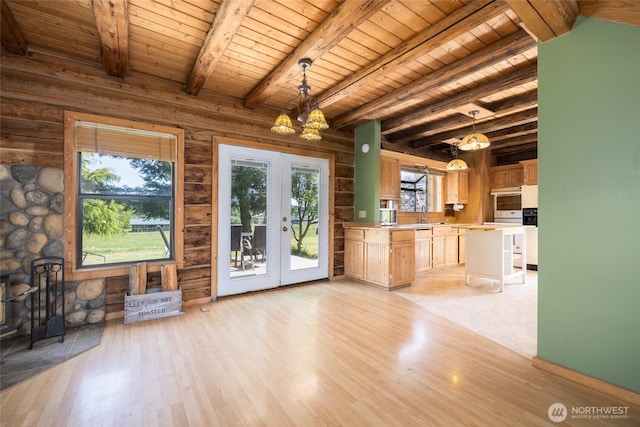 kitchen featuring french doors, light countertops, light wood finished floors, wood ceiling, and beam ceiling