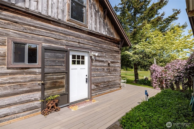 view of exterior entry with a deck