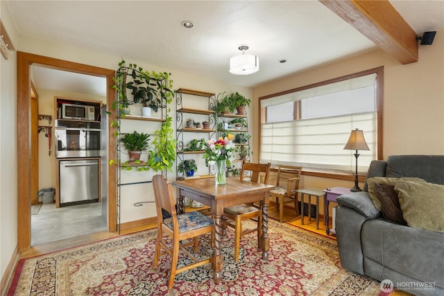 4808 38th Ave SW, Seattle, WA 98126 - dining area with light wood-type flooring and beam ceiling
