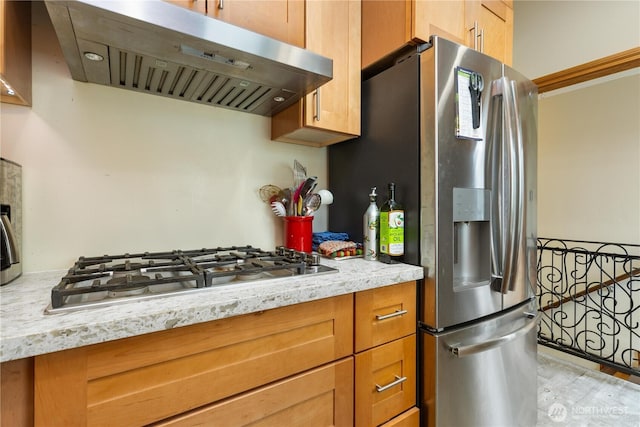 4808 38th Ave SW, Seattle, WA 98126 - kitchen featuring extractor fan, appliances with stainless steel finishes, light stone counters, and light wood finished floors