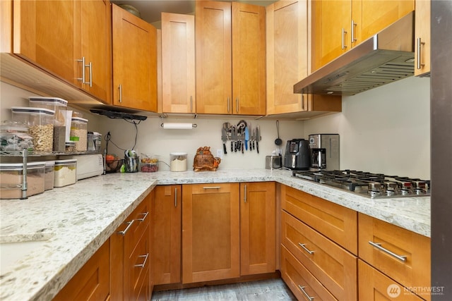 4808 38th Ave SW, Seattle, WA 98126 - kitchen featuring under cabinet range hood, stainless steel gas cooktop, and brown cabinets