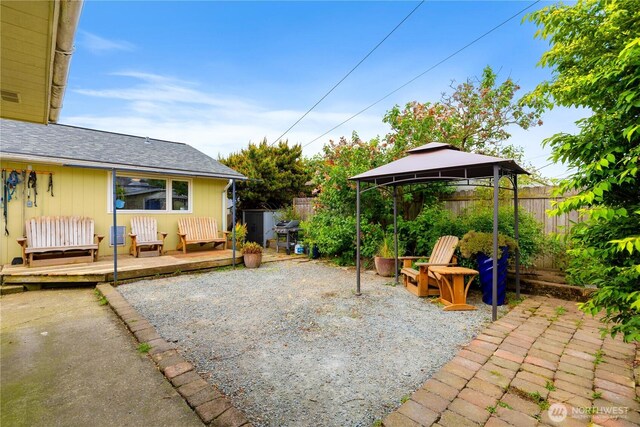 4808 38th Ave SW, Seattle, WA 98126 - fenced backyard featuring a gazebo, a wooden deck, a patio area, and grilling area