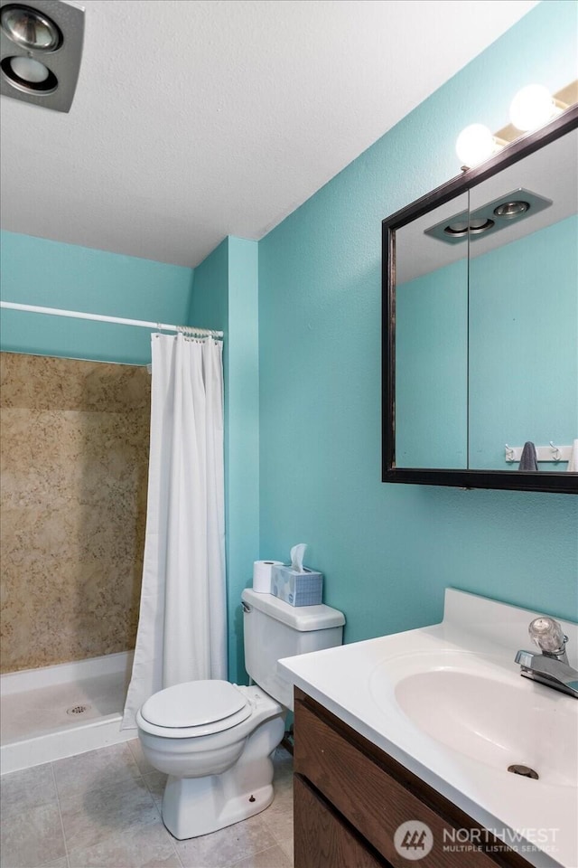 17910 Spruce Way, Lynnwood, WA 98037 - bathroom with toilet, a shower stall, vanity, and tile patterned floors