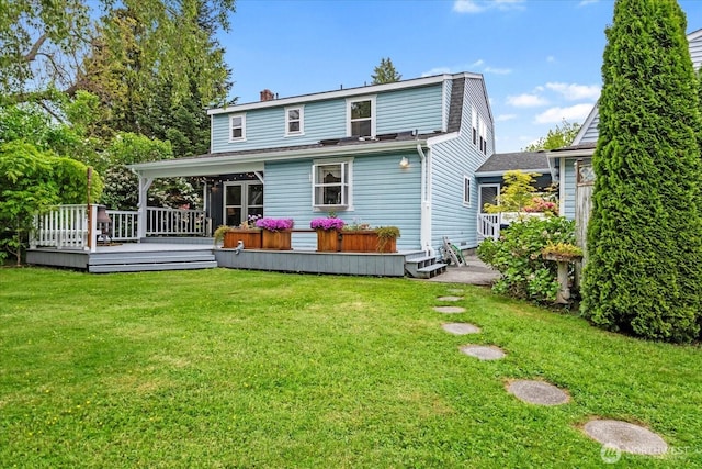17910 Spruce Way, Lynnwood, WA 98037 - back of property featuring a chimney, a lawn, a wooden deck, and a shingled roof