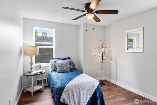 17910 Spruce Way, Lynnwood, WA 98037 - bedroom with baseboards, wood finished floors, a textured ceiling, and ceiling fan