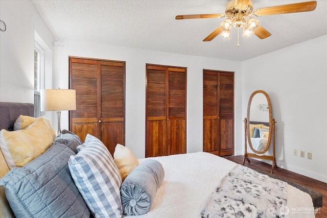 17910 Spruce Way, Lynnwood, WA 98037 - bedroom with multiple closets, wood finished floors, baseboards, and ceiling fan