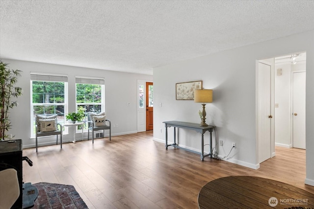 17910 Spruce Way, Lynnwood, WA 98037 - living room with a textured ceiling, wood finished floors, and baseboards