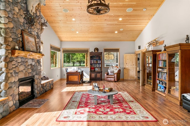 2720 NW Cascade Ave, East Wenatchee, WA 98802 - living area with a stone fireplace, wooden ceiling, wood finished floors, recessed lighting, and high vaulted ceiling