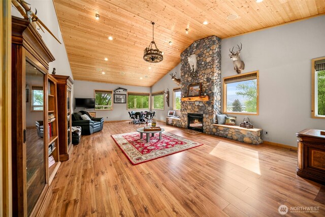 2720 NW Cascade Ave, East Wenatchee, WA 98802 - living area featuring wood ceiling, a fireplace, baseboards, wood finished floors, and high vaulted ceiling