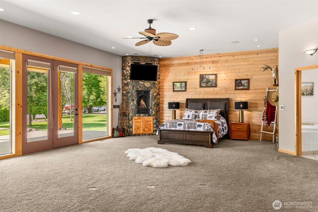 2720 NW Cascade Ave, East Wenatchee, WA 98802 - bedroom featuring carpet, access to exterior, wooden walls, recessed lighting, and a fireplace