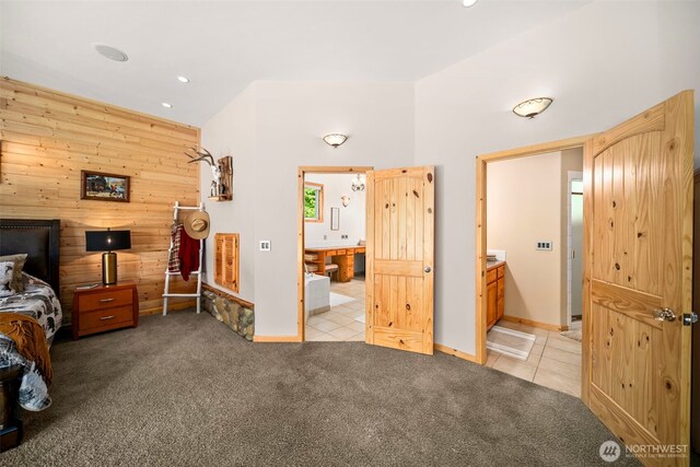 2720 NW Cascade Ave, East Wenatchee, WA 98802 - bedroom featuring light colored carpet, wood walls, recessed lighting, light tile patterned floors, and connected bathroom