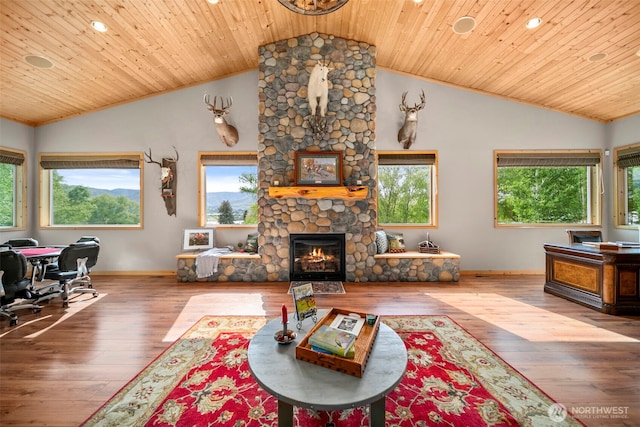 2720 NW Cascade Ave, East Wenatchee, WA 98802 - living area featuring lofted ceiling, a stone fireplace, baseboards, wood finished floors, and a desk
