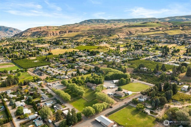 2720 NW Cascade Ave, East Wenatchee, WA 98802 - aerial view of property and surrounding area featuring a mountain backdrop and nearby suburban area