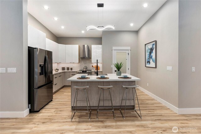 16250 SE Lake Moneysmith, Auburn, WA 98092 - kitchen featuring stainless steel fridge, wall chimney exhaust hood, modern cabinets, light countertops, and an island with sink