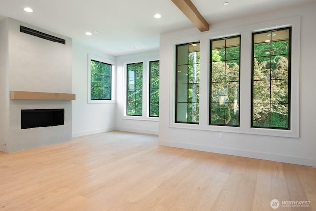 706 N 59th St, Seattle, WA 98103 - unfurnished living room with a fireplace, wood finished floors, baseboards, beamed ceiling, and recessed lighting