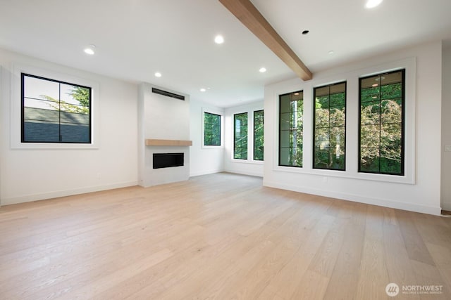706 N 59th St, Seattle, WA 98103 - unfurnished living room with plenty of natural light, a fireplace, light wood finished floors, baseboards, and beam ceiling