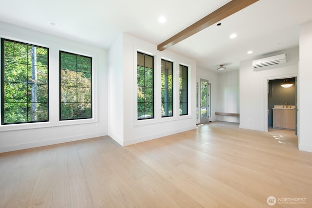 706 N 59th St, Seattle, WA 98103 - spare room with an AC wall unit, healthy amount of natural light, light wood-type flooring, beamed ceiling, and recessed lighting