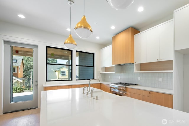 706 N 59th St, Seattle, WA 98103 - kitchen featuring a sink, light countertops, modern cabinets, backsplash, and recessed lighting