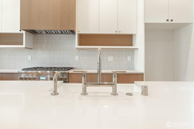 706 N 59th St, Seattle, WA 98103 - kitchen featuring range hood, light countertops, and white cabinetry