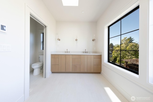 706 N 59th St, Seattle, WA 98103 - bathroom with toilet, double vanity, and tile patterned floors