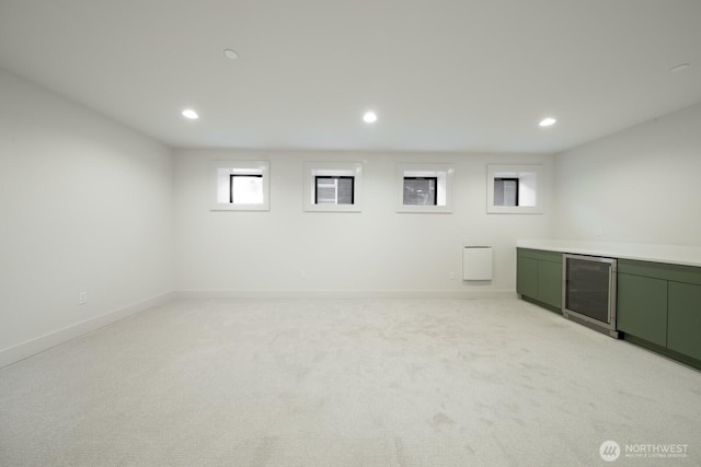 706 N 59th St, Seattle, WA 98103 - below grade area featuring beverage cooler, recessed lighting, light carpet, and baseboards