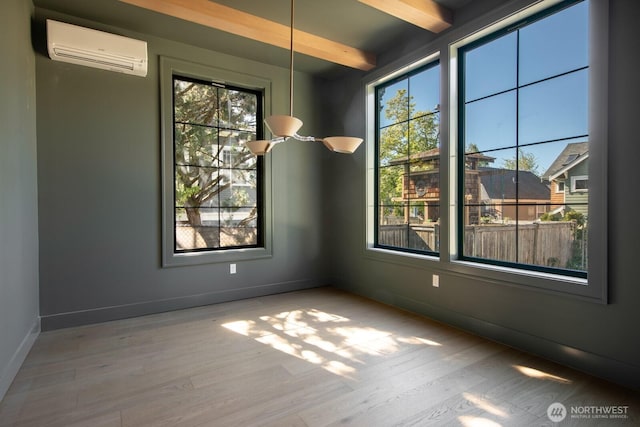 706 N 59th St, Seattle, WA 98103 - unfurnished dining area featuring an AC wall unit, wood finished floors, plenty of natural light, and beamed ceiling