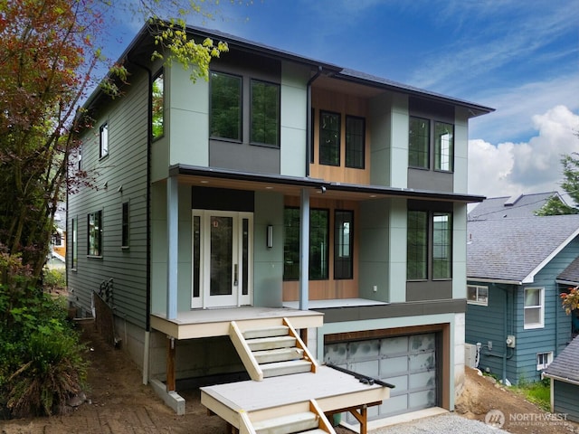 706 N 59th St, Seattle, WA 98103 - contemporary house with an attached garage, stucco siding, and gravel driveway