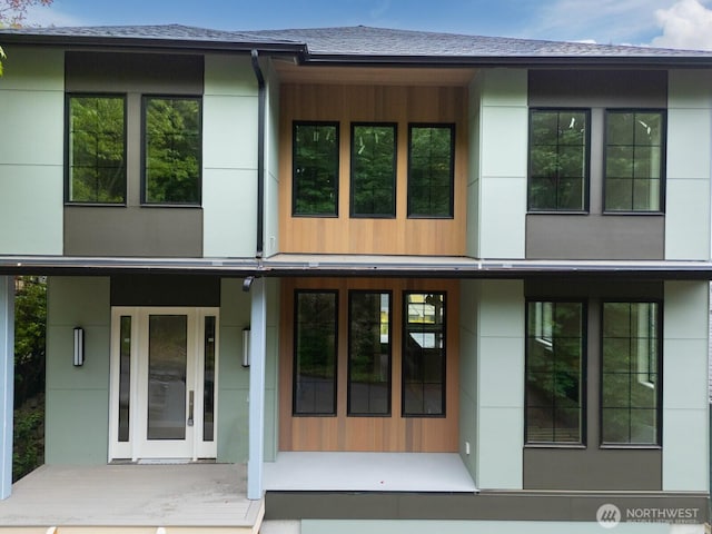 706 N 59th St, Seattle, WA 98103 - back of property featuring a shingled roof and stucco siding