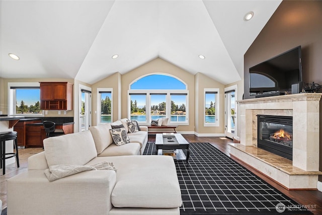 2815 211th Ave E, Lake Tapps, WA 98391 - living room featuring healthy amount of natural light, vaulted ceiling, a high end fireplace, recessed lighting, and wood finished floors