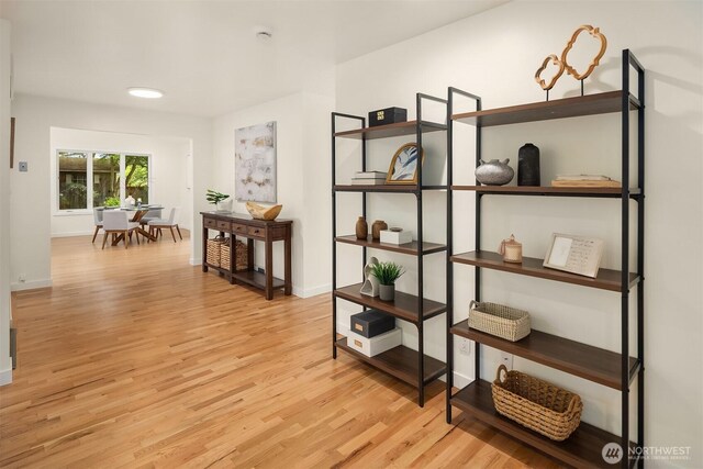 hallway with wood finished floors and baseboards