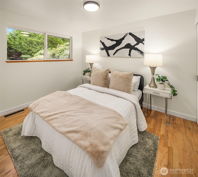 bedroom featuring baseboards and light wood-style floors