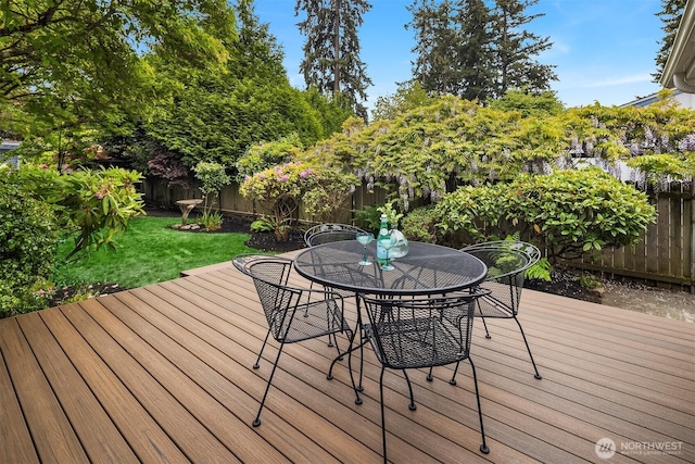 wooden terrace with outdoor dining area