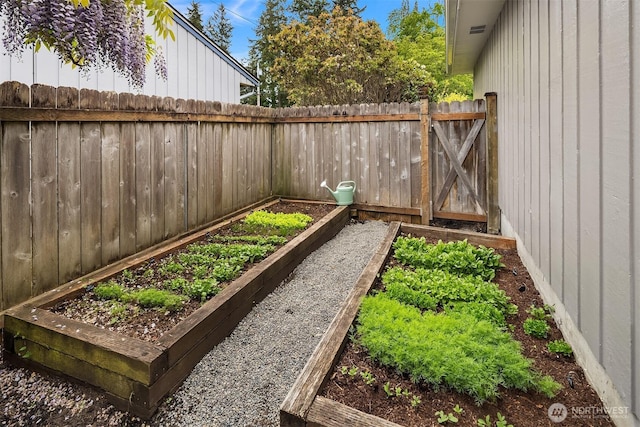 view of yard with a garden and fence