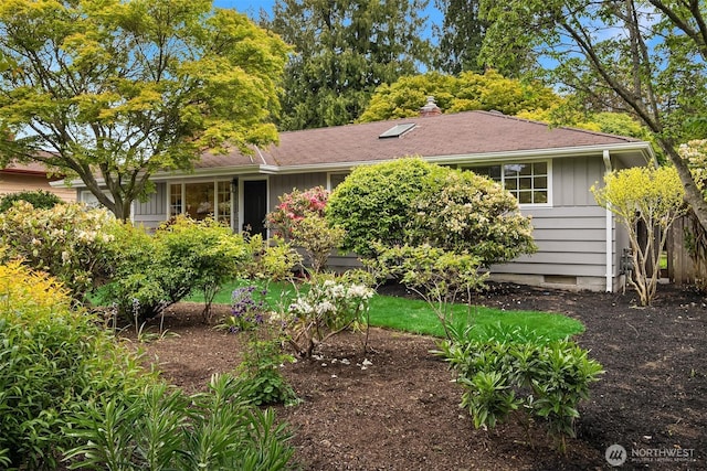 view of front of property with board and batten siding, crawl space, and a chimney
